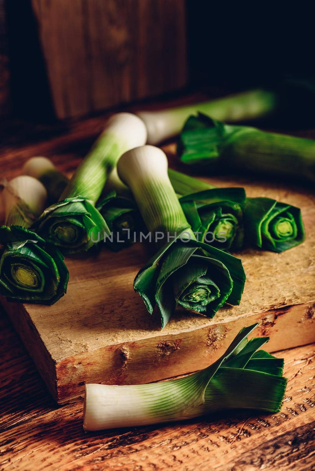 Fresh green leek on rustic cutting board