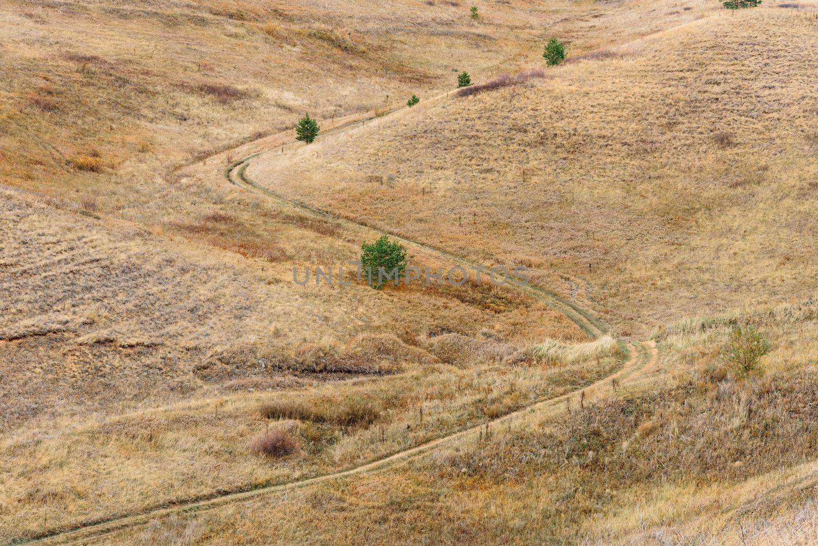 S curve of dirt road on the hillside