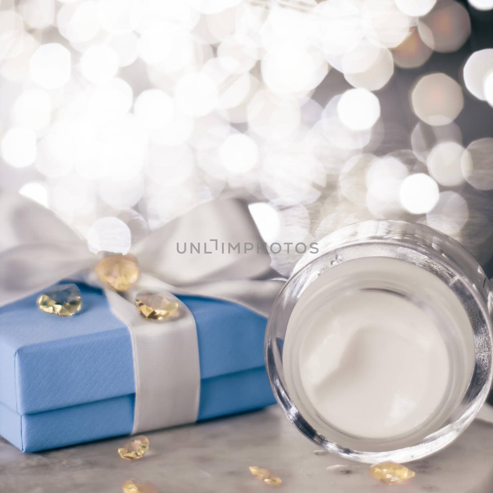 Cosmetic branding, Christmas glitter and girly blog concept - Holiday make-up foundation base, concealer and blue gift box, luxury cosmetics present and blank label products for beauty brand design