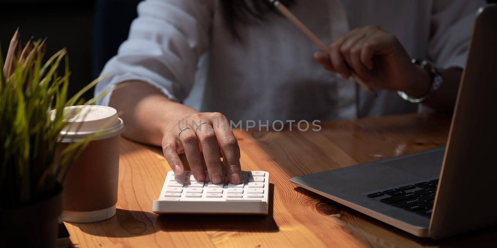 accounting concept. businesswoman working using calculator with laptop computer in office