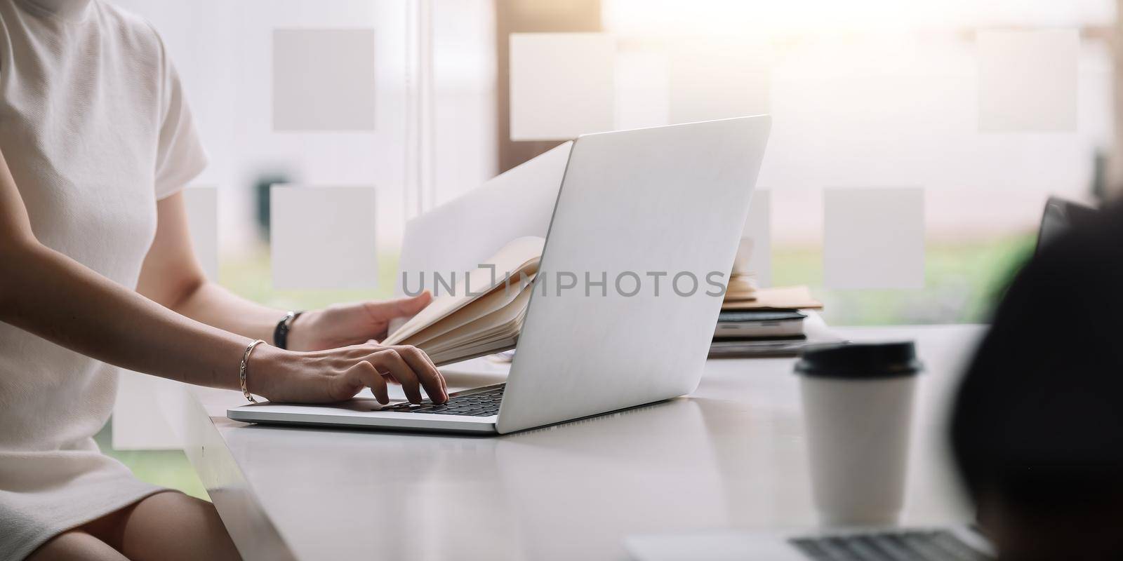 Businesswoman working on computer at table in office, closeup. Banner design by nateemee