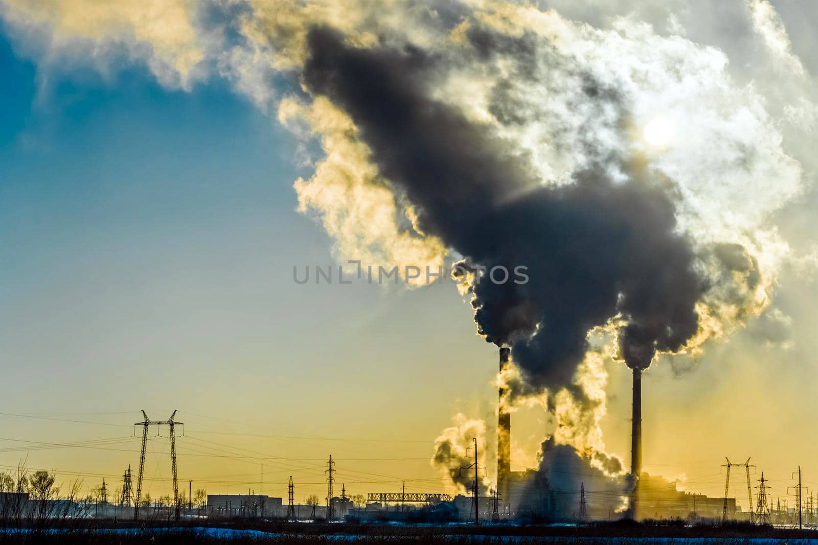 Smoking factory chimneys.Environmental problem of pollution of environment and air in large cities.Climate change,ecology and global warming.The sky is smoky with toxic substances.Soot from factories by YevgeniySam