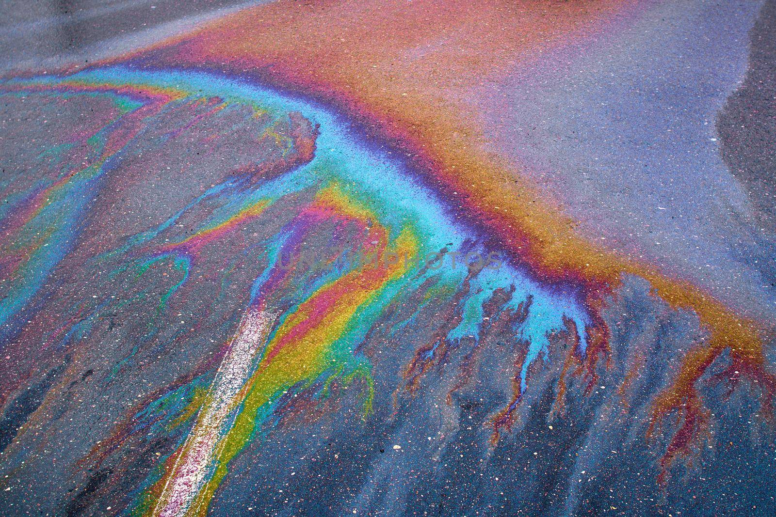 Oil stain on Asphalt, color Gasoline fuel spots on Asphalt Road as Texture or Background