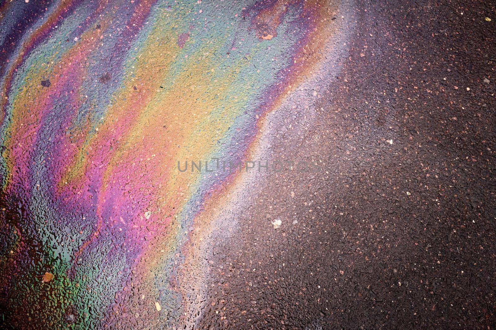 Oil stain on Asphalt, color Gasoline fuel spots on Asphalt Road as Texture or Background