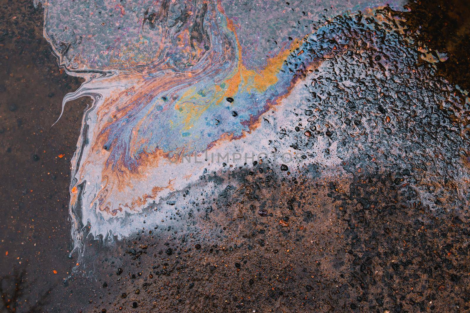 Oil stain on Asphalt, color Gasoline fuel spots on Asphalt Road as Texture or Background