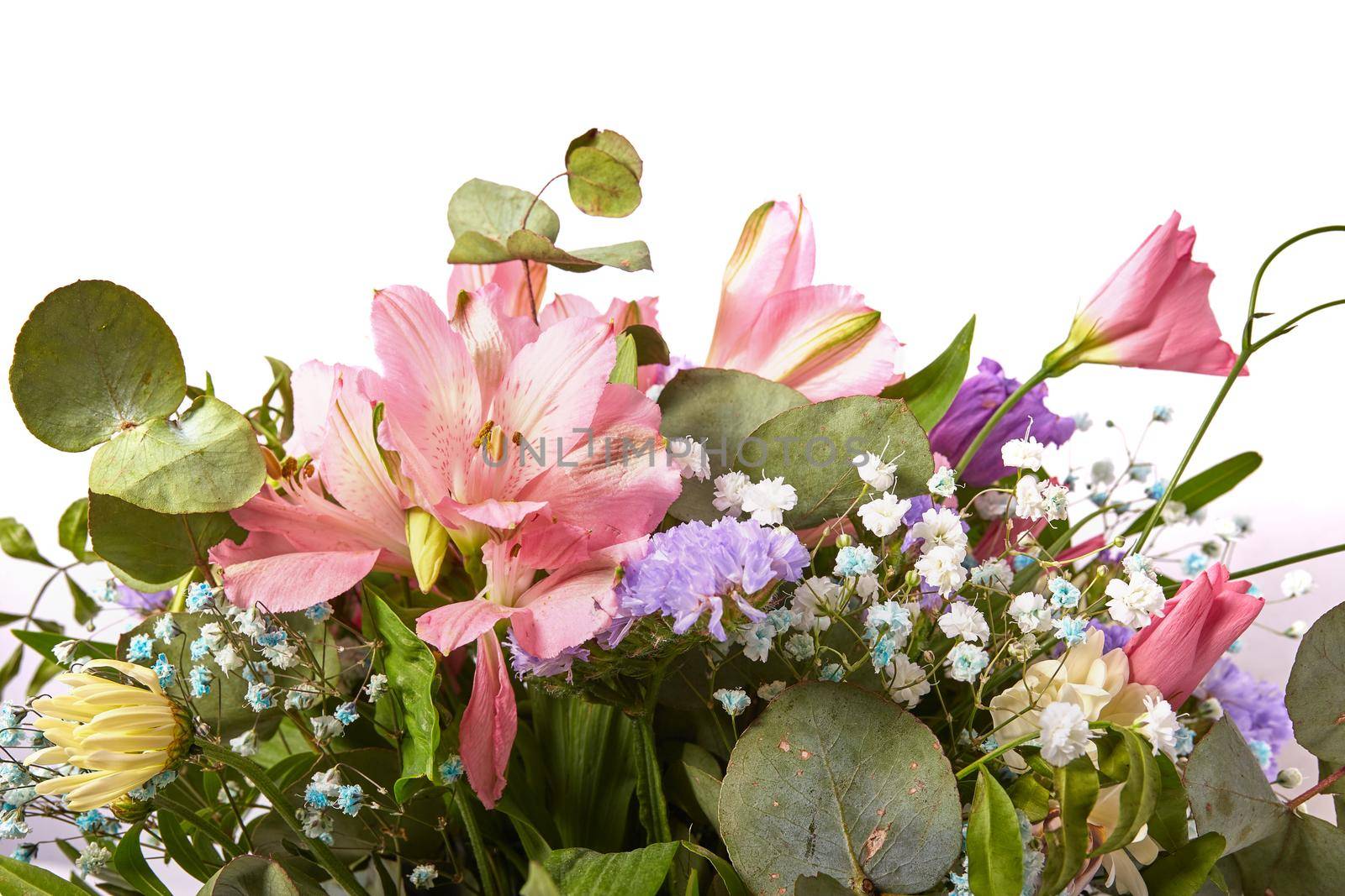 Beautiful bouquet of natural flowers close up on a white background. Selective focus