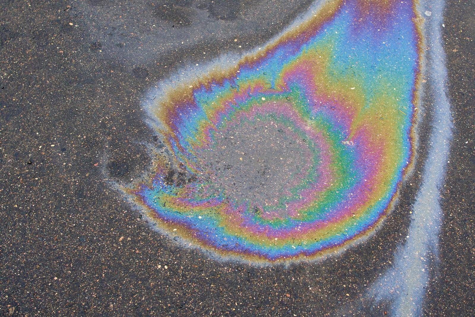 Abstract background with oil stain of oil products.Oil stain on Asphalt, Gasoline fuel spots on Asphalt Road as Texture or Background.