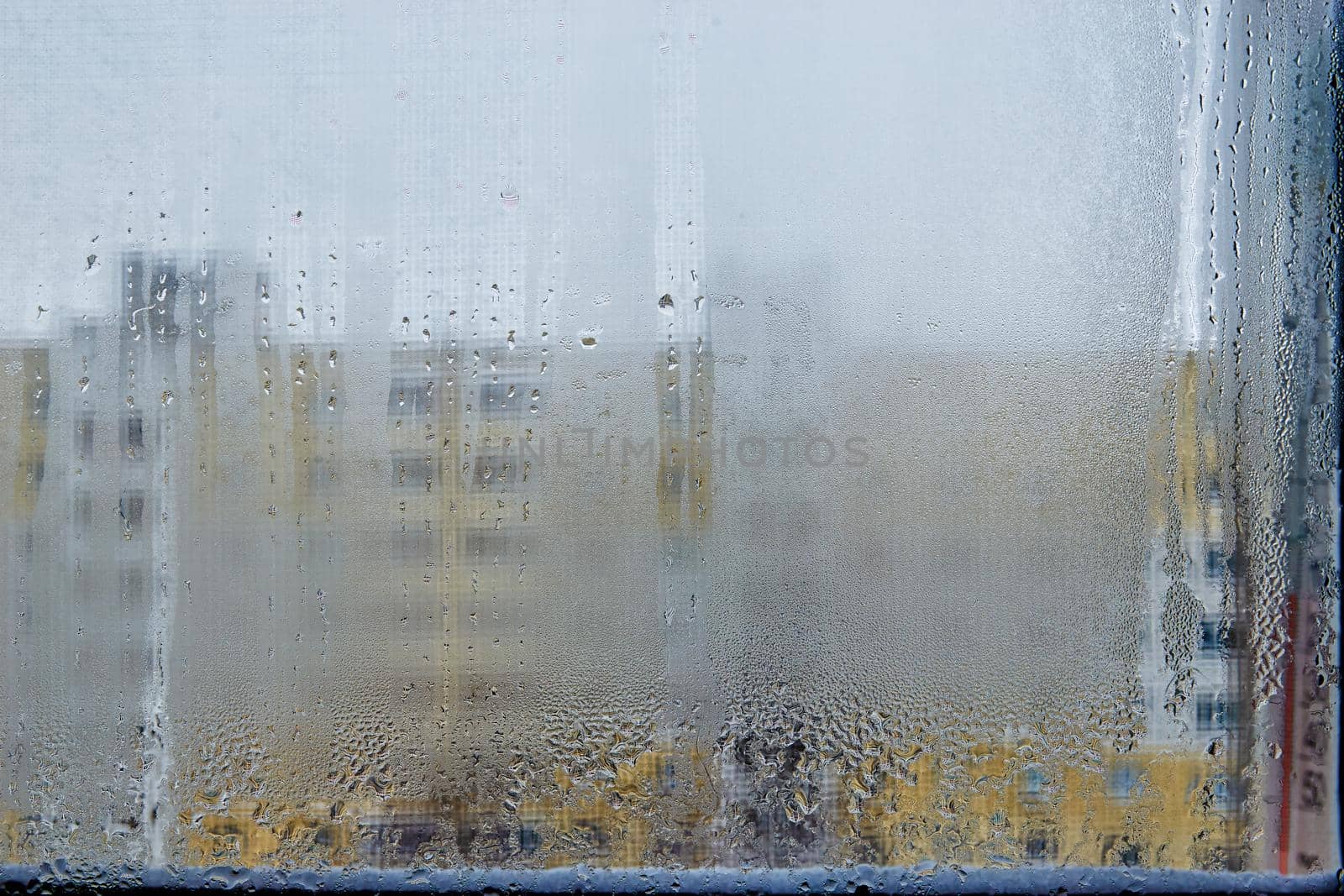 View of city houses through a fogged window close-up