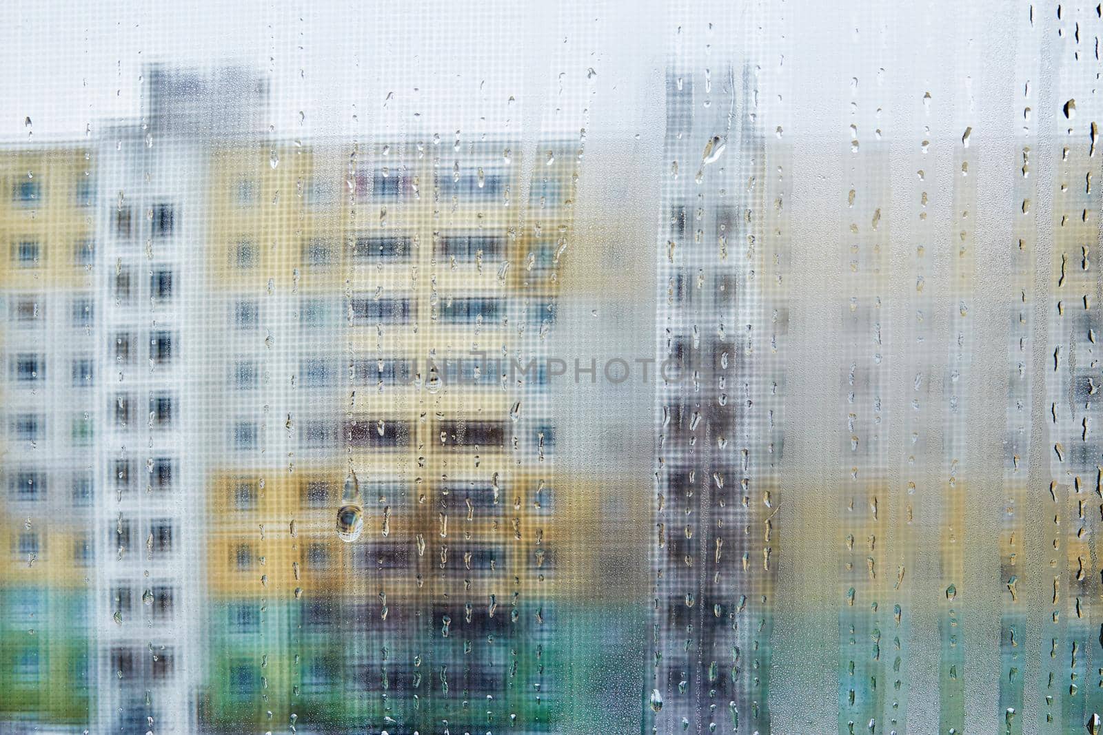 View of city houses through a fogged window close-up