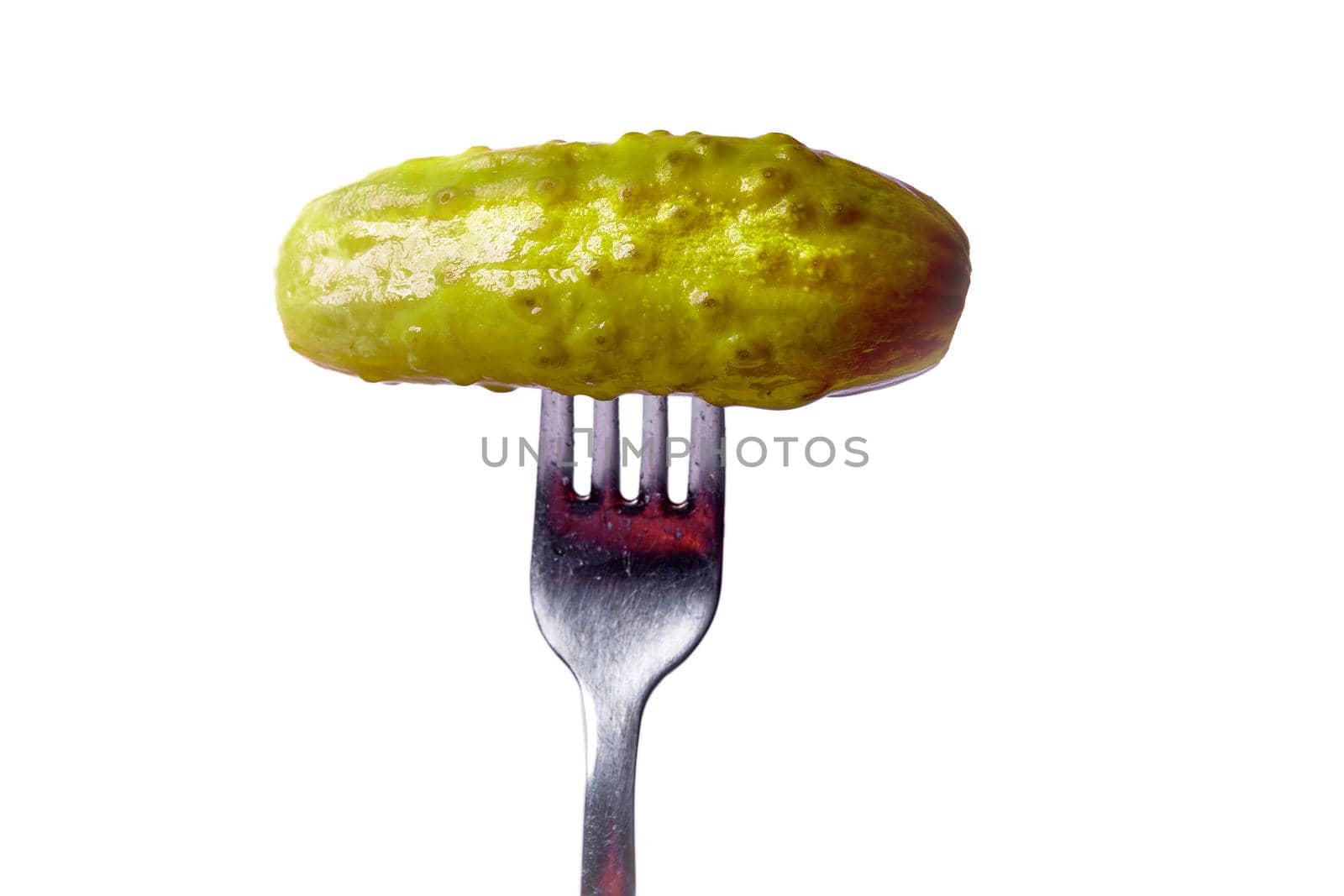 pickled cucumber on a plug on a white background is isolated