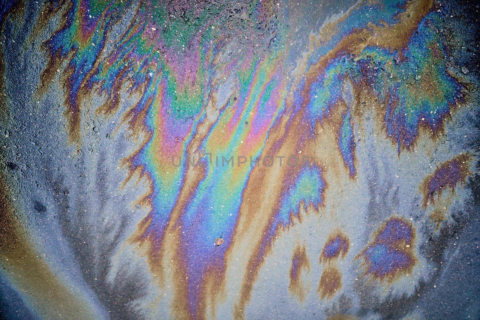Beautiful abstract colorful background, texture, stains from engine oil on the asphalt.Colorful gas stain on wet asphalt