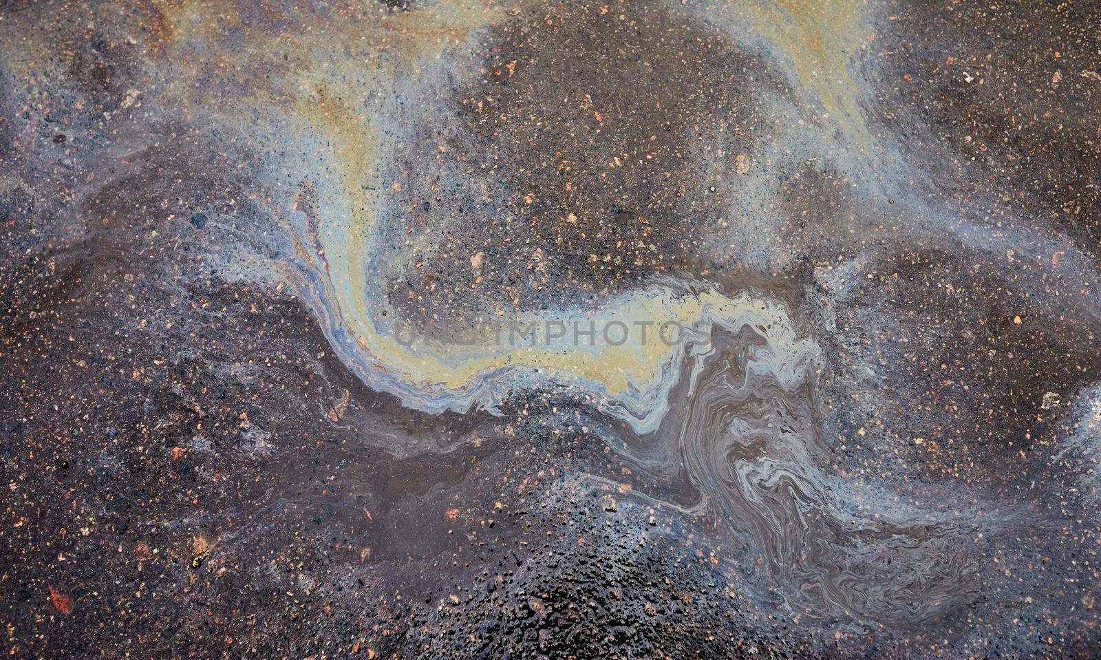 Abstract background with oil stain of oil products.Oil stain on Asphalt, color Gasoline fuel spots on Asphalt Road as Texture or Background.