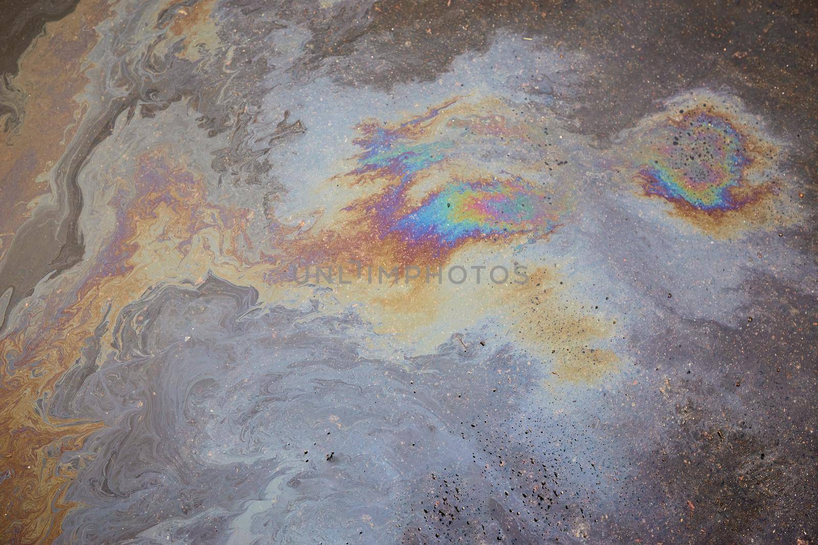 Beautiful abstract colorful background, texture, stains from engine oil on the asphalt.Colorful gas stain on wet asphalt