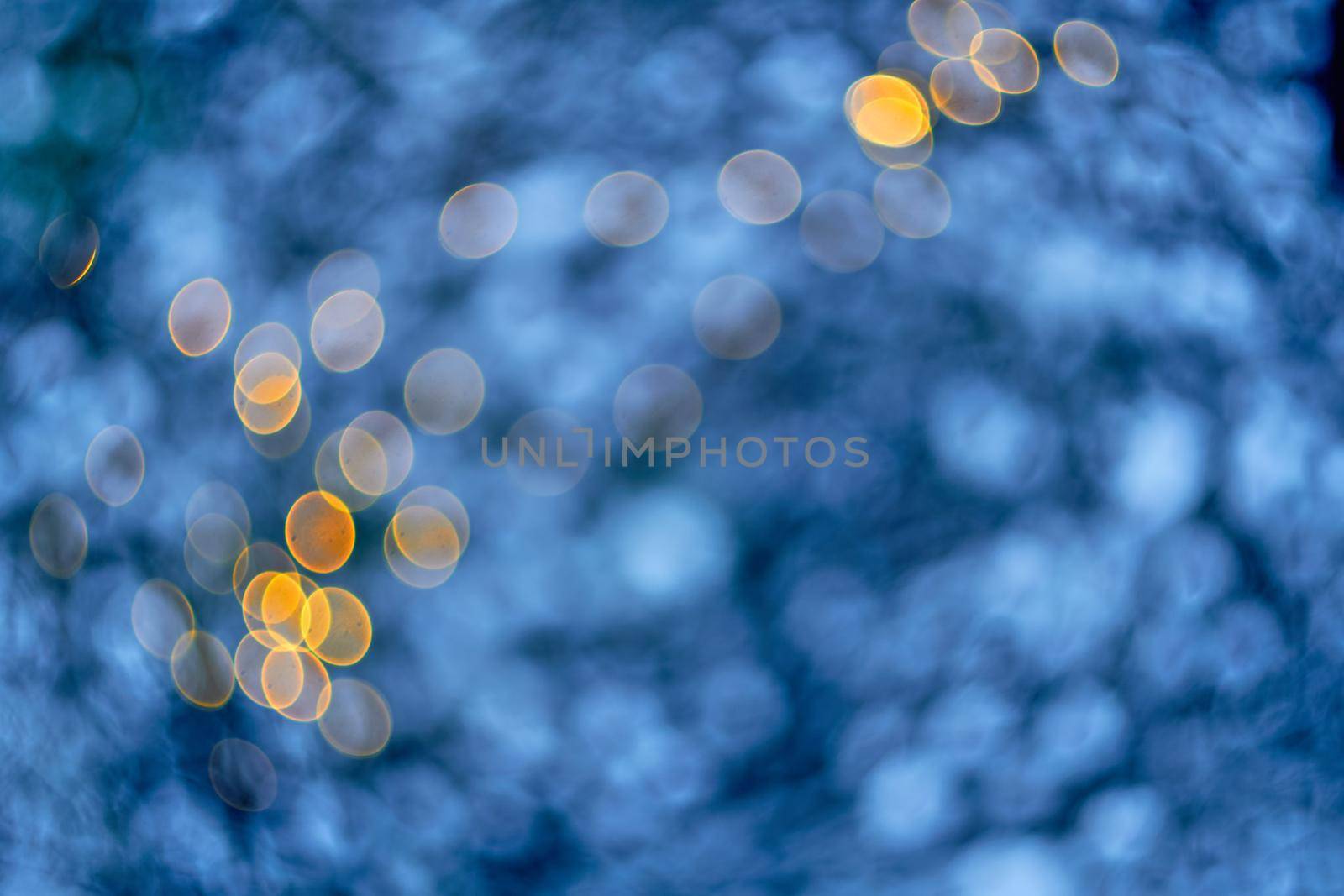 Colored lights Christmas garlands. Colorful abstract background. Blur and bokeh. Defocused bokeh lights