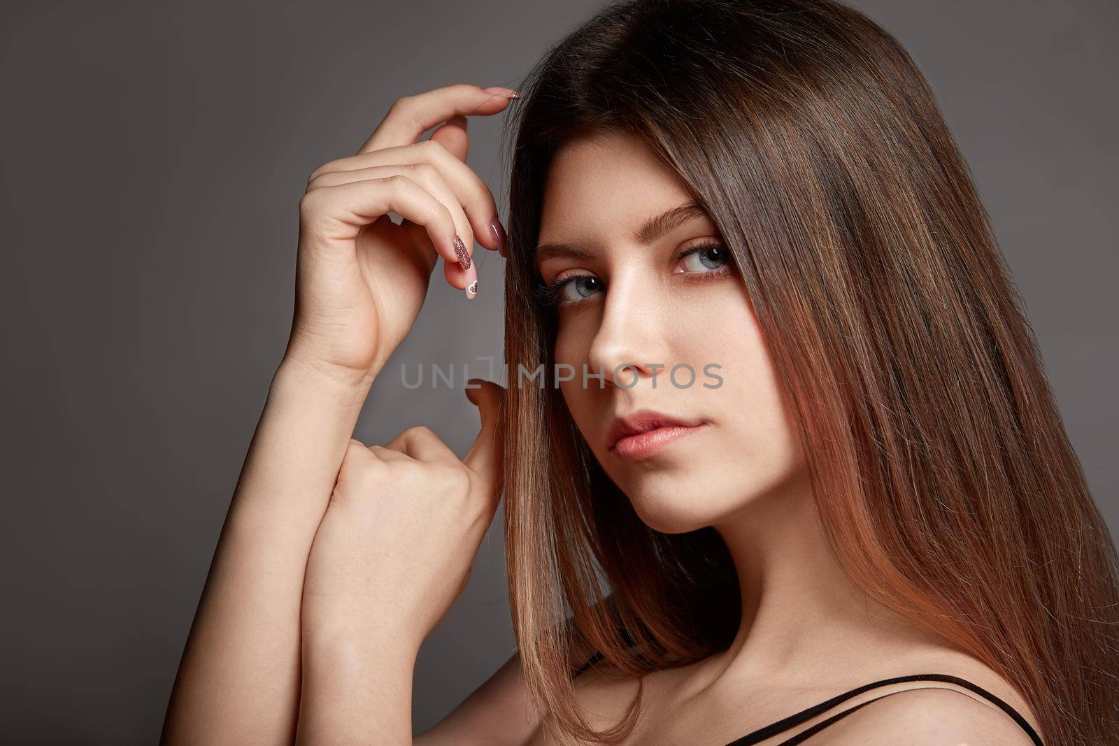 Beautiful young woman portrait, Smiling cute girl with long hair on gray background