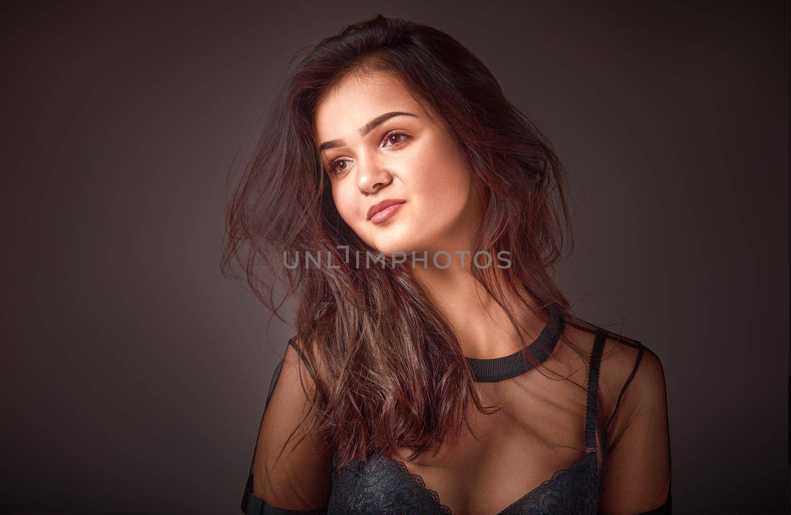fashionable young woman in studio on dark background