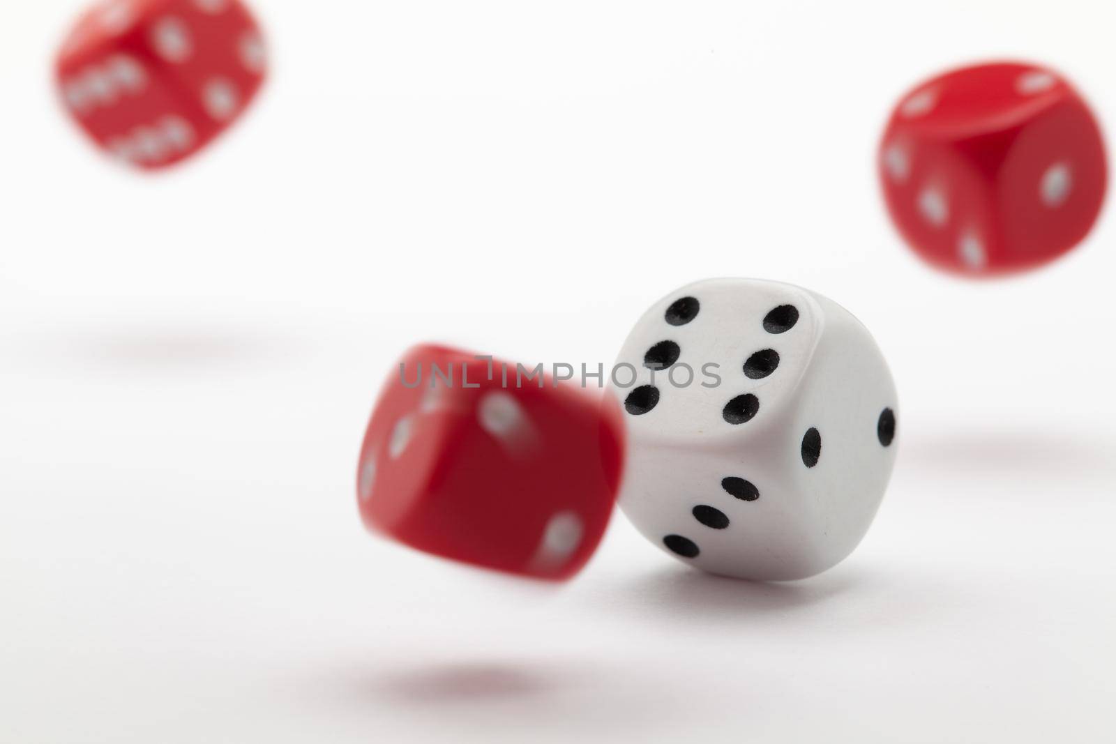 Playing dice at white wooden background.  by CaptureLight