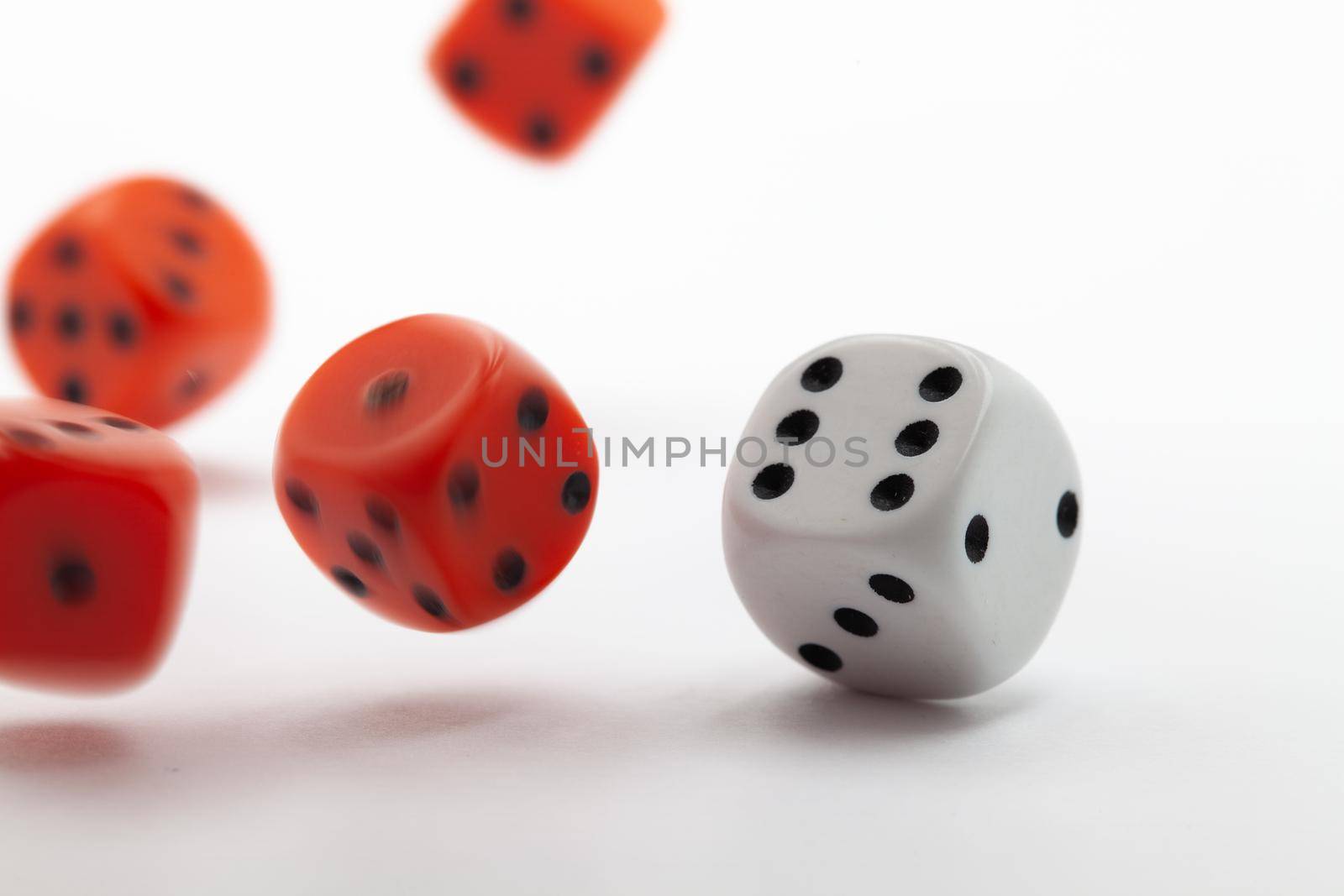 Playing dice at white wooden background.  by CaptureLight