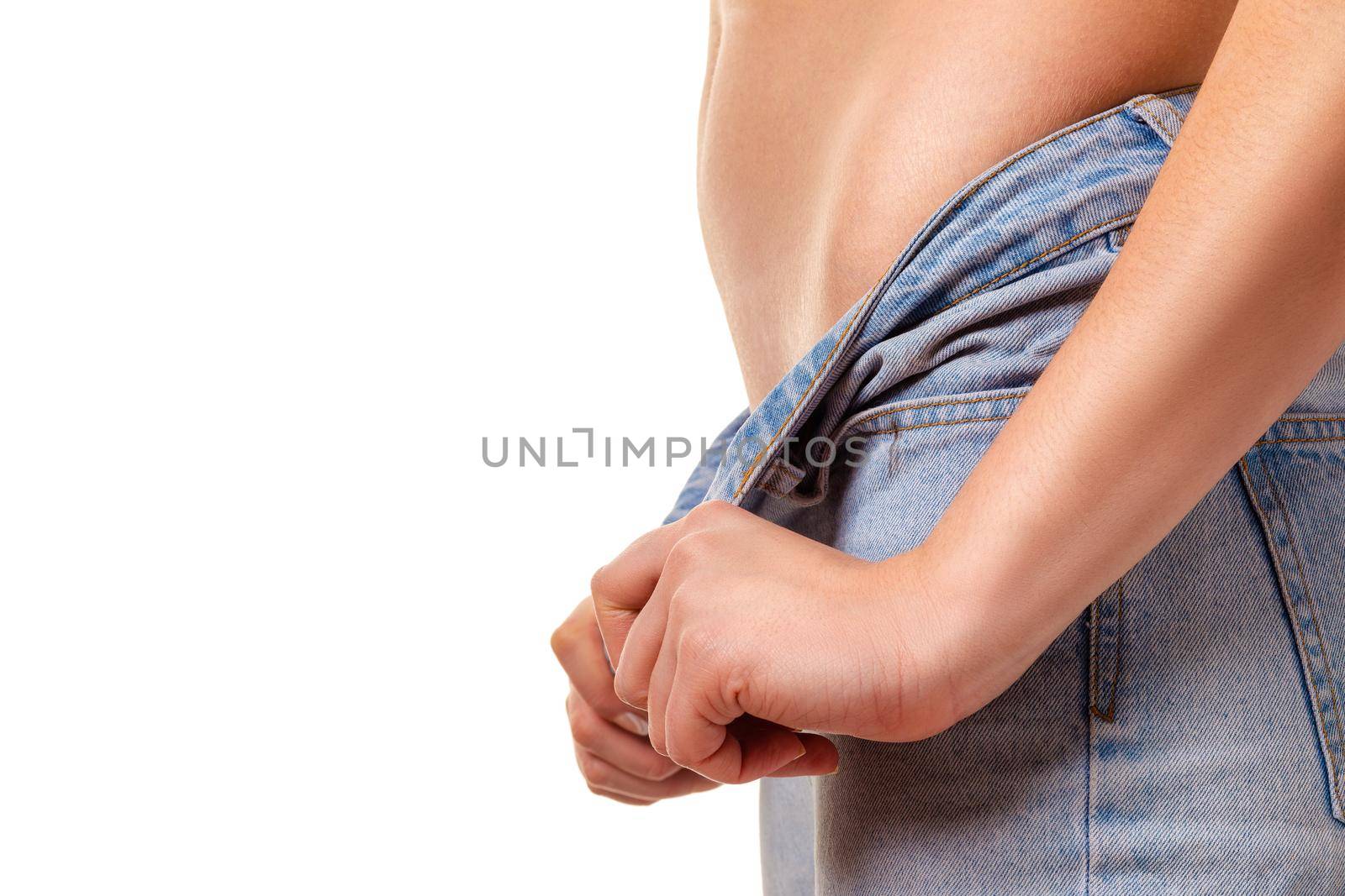 Closeup image of a female hands unzip jeans. Isolate on white background