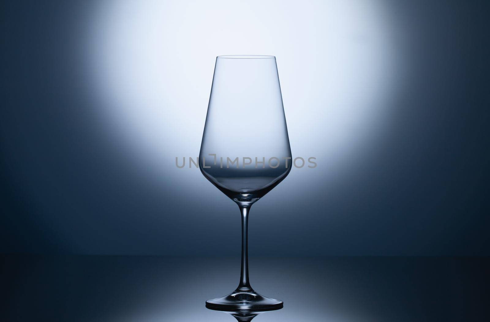 Empty wine glasses on a blue clean gradient background.  by CaptureLight