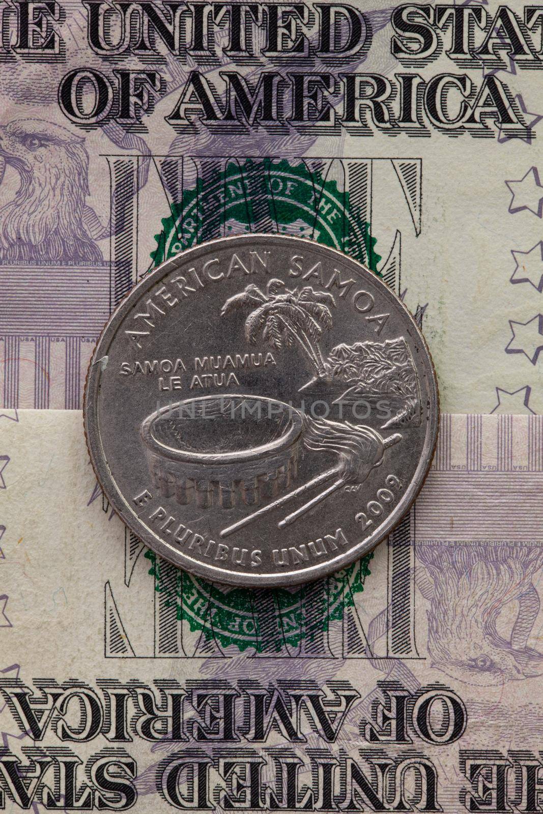A quarter of American Samoa on US dollar bills. Symmetric composition of US dollar bills and a quarter of American Samoa