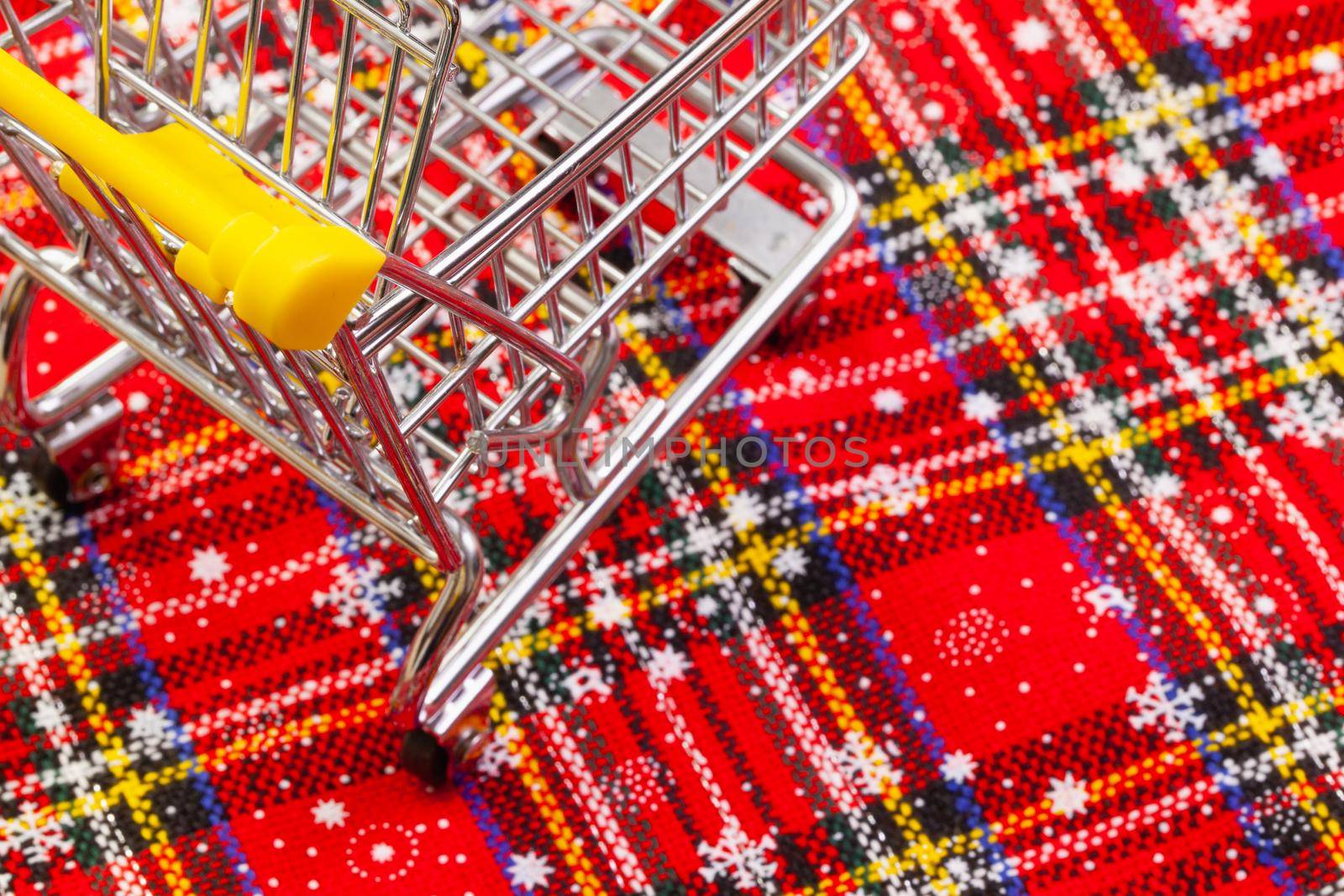 Shopping trolley and typical Christmas decoration. Winter holidays. Merry christmas and happy new year concept.