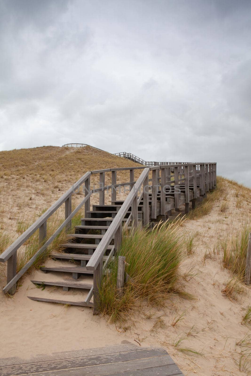 The wooden stairs on the 26 m high panorama dune without tourists after the coronavirus pandemic. The place close to town Petten aan Zee guarantees a fantastic view of the North Sea and the beach.