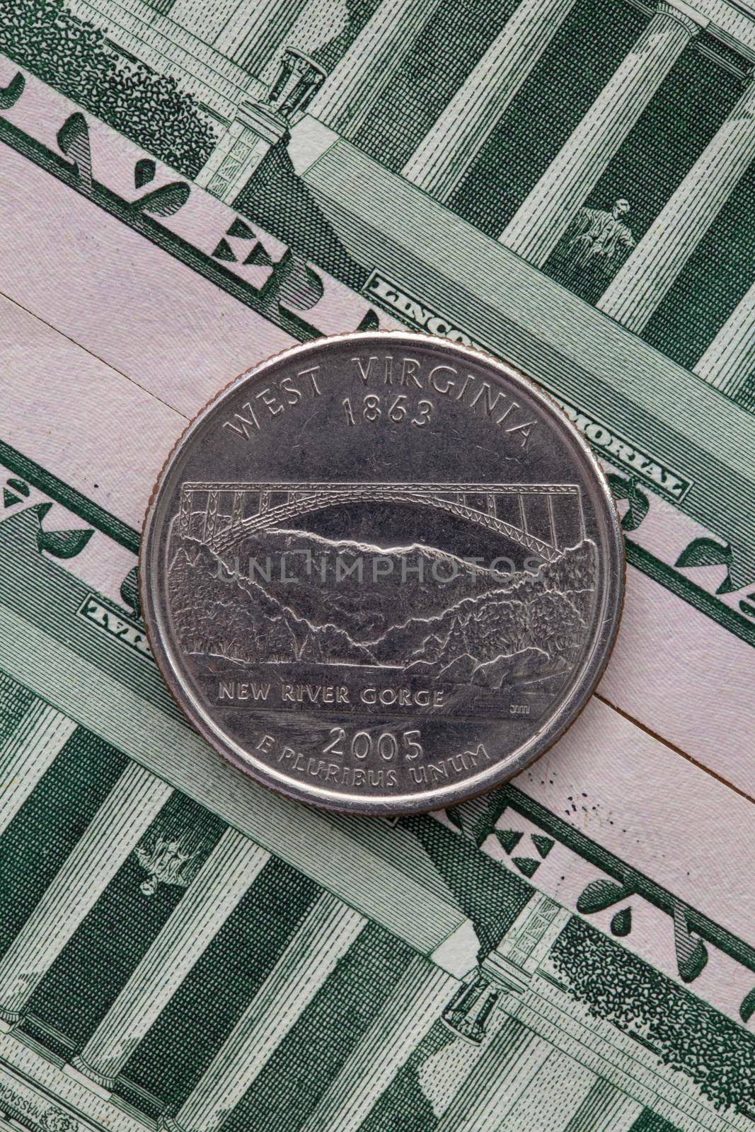 A quarter of West Virginia on US dollar bills. Symmetric composition of US dollar bills and a quarter of West Virginia.