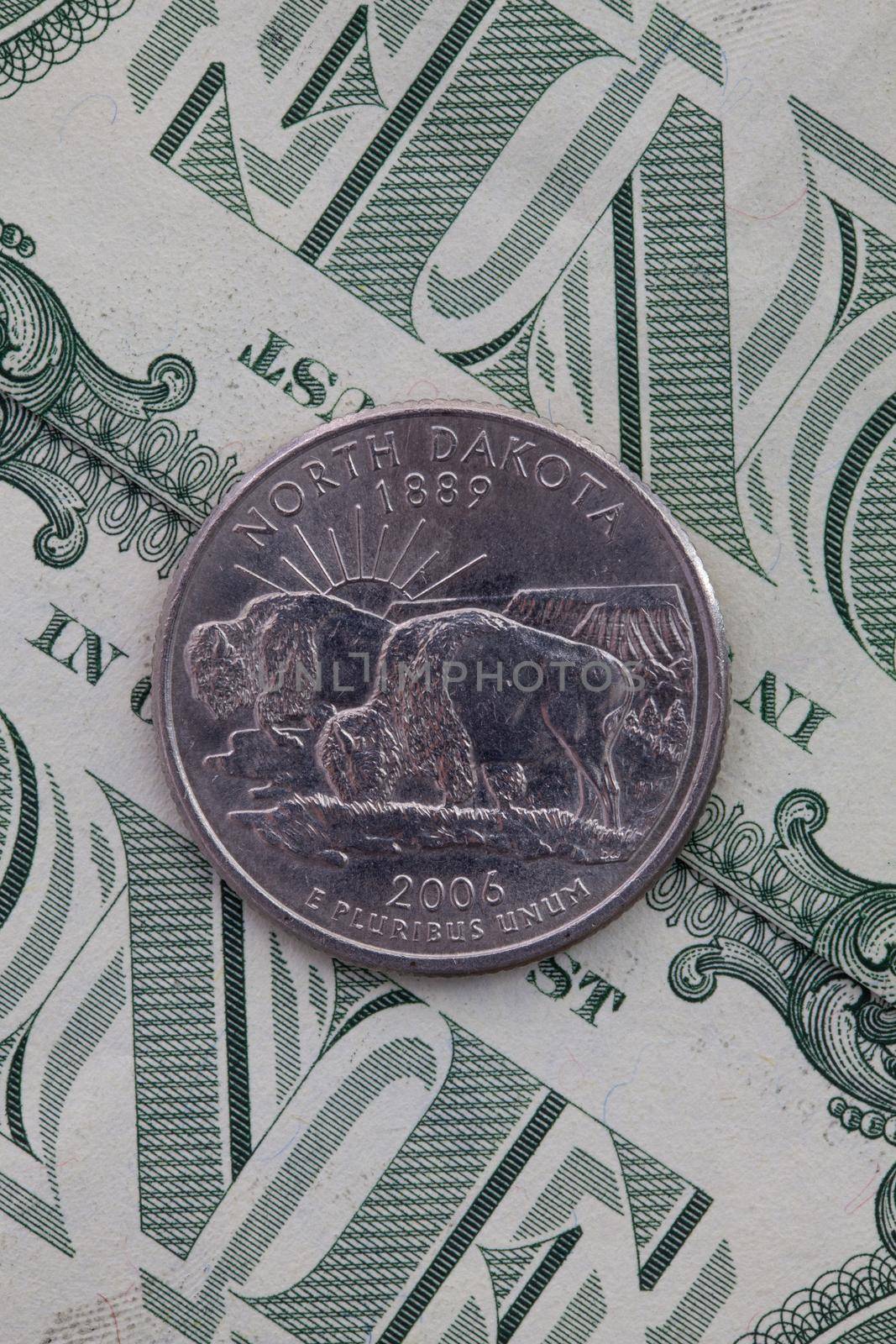 A quarter of North Dakota on US dollar bills. Symmetric composition of US dollar bills and a quarter of North Dakota.