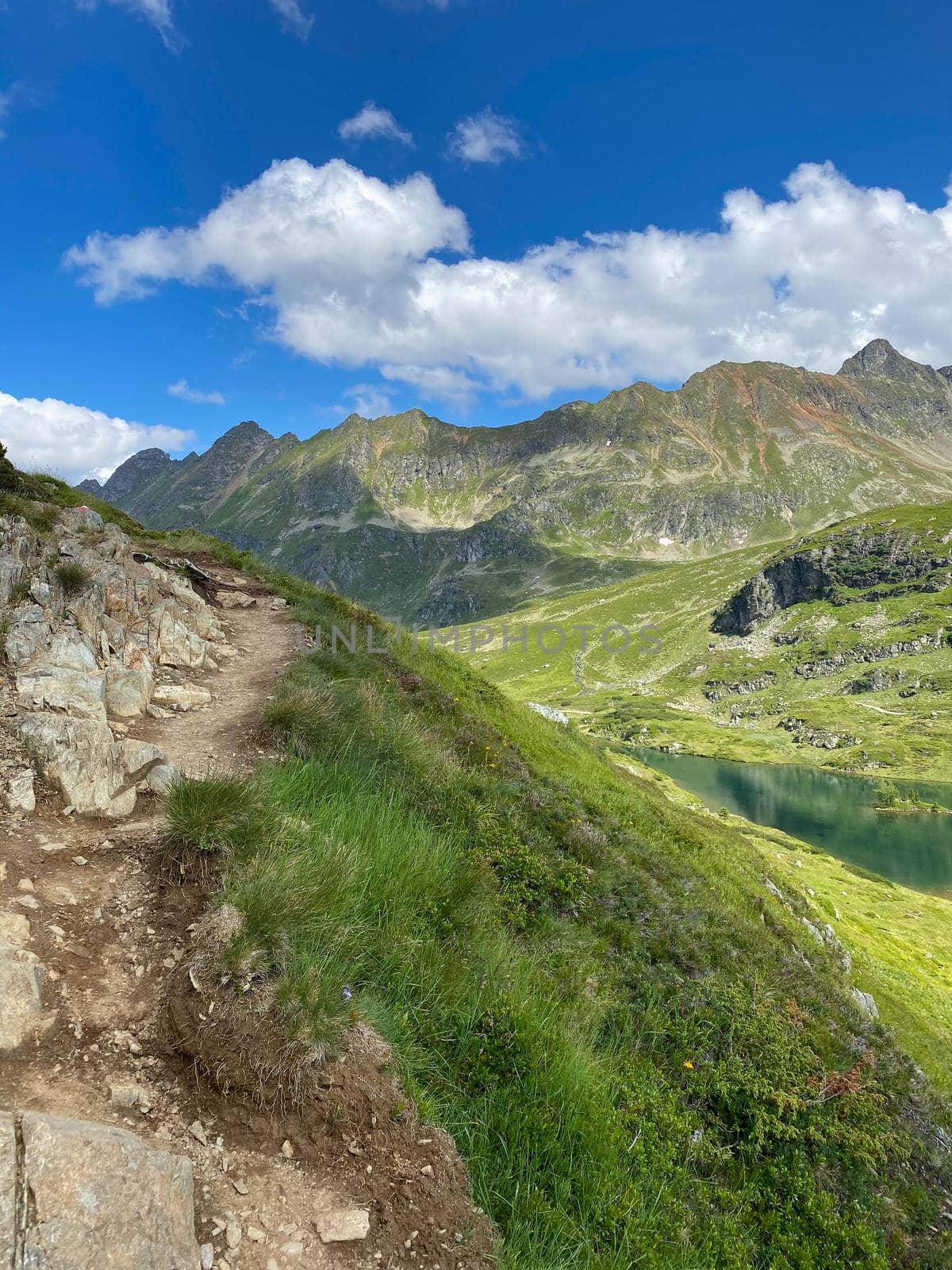 Steep footpath on the shore of the Lake Giglachsee in the Styrian Tauern - Austria. Lake Giglachsee in the Styrian Tauern - Austria. The place without  tourists after the coronavirus pandemic.