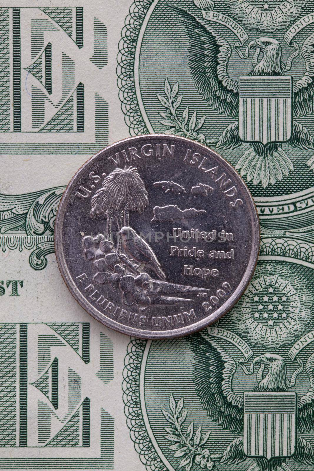 A quarter of U.S. Virgin Islands on US dollar bills. Symmetric composition of US dollar bills and a quarter of U.S. Virgin Islands