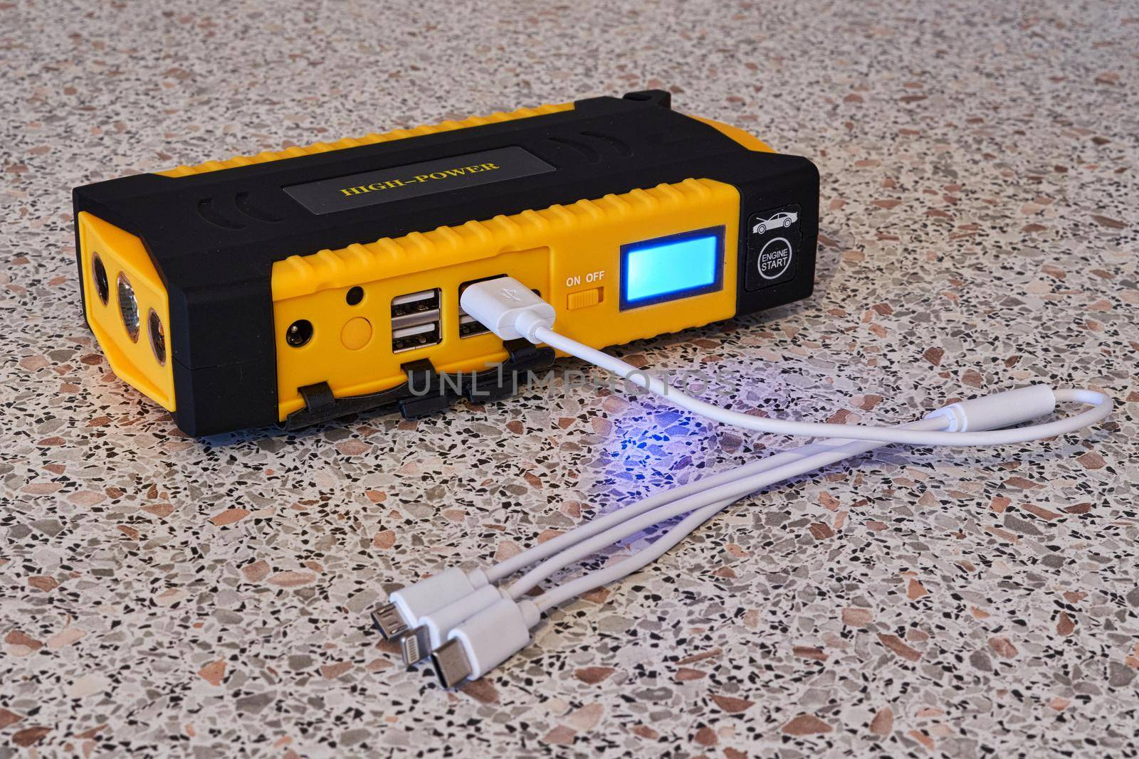 Yellow power bank with a universal cable for different types of charging by vizland