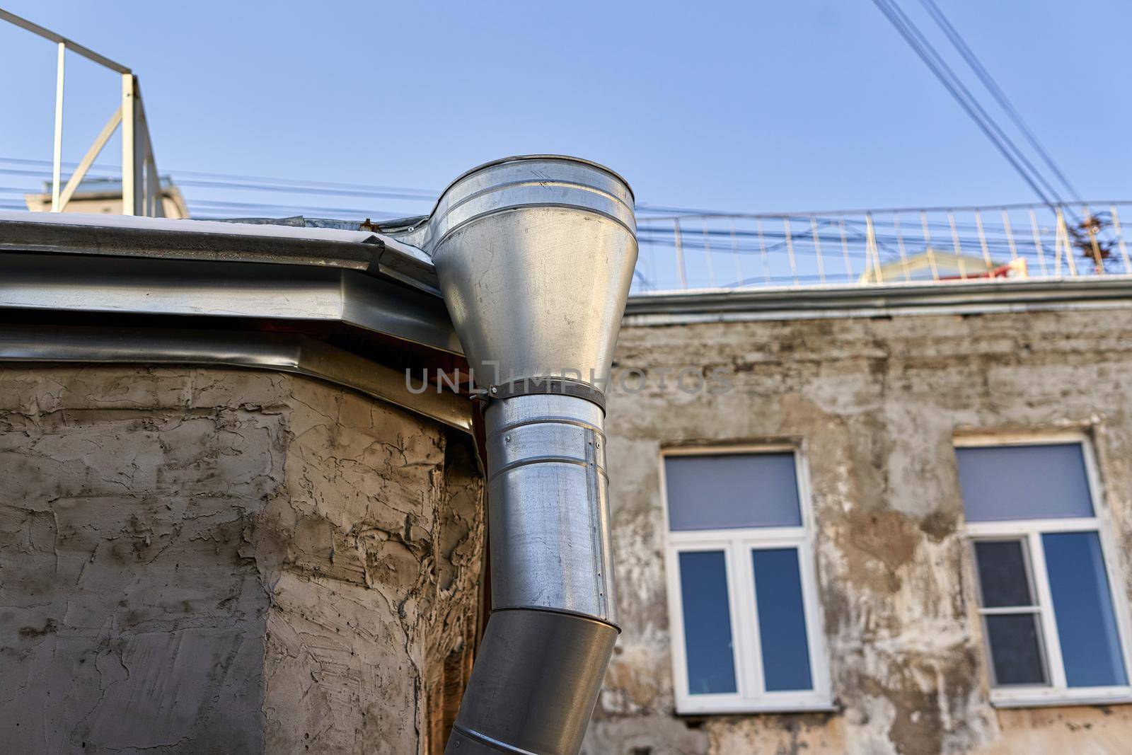 New metal gutter on the wall of an old house by vizland