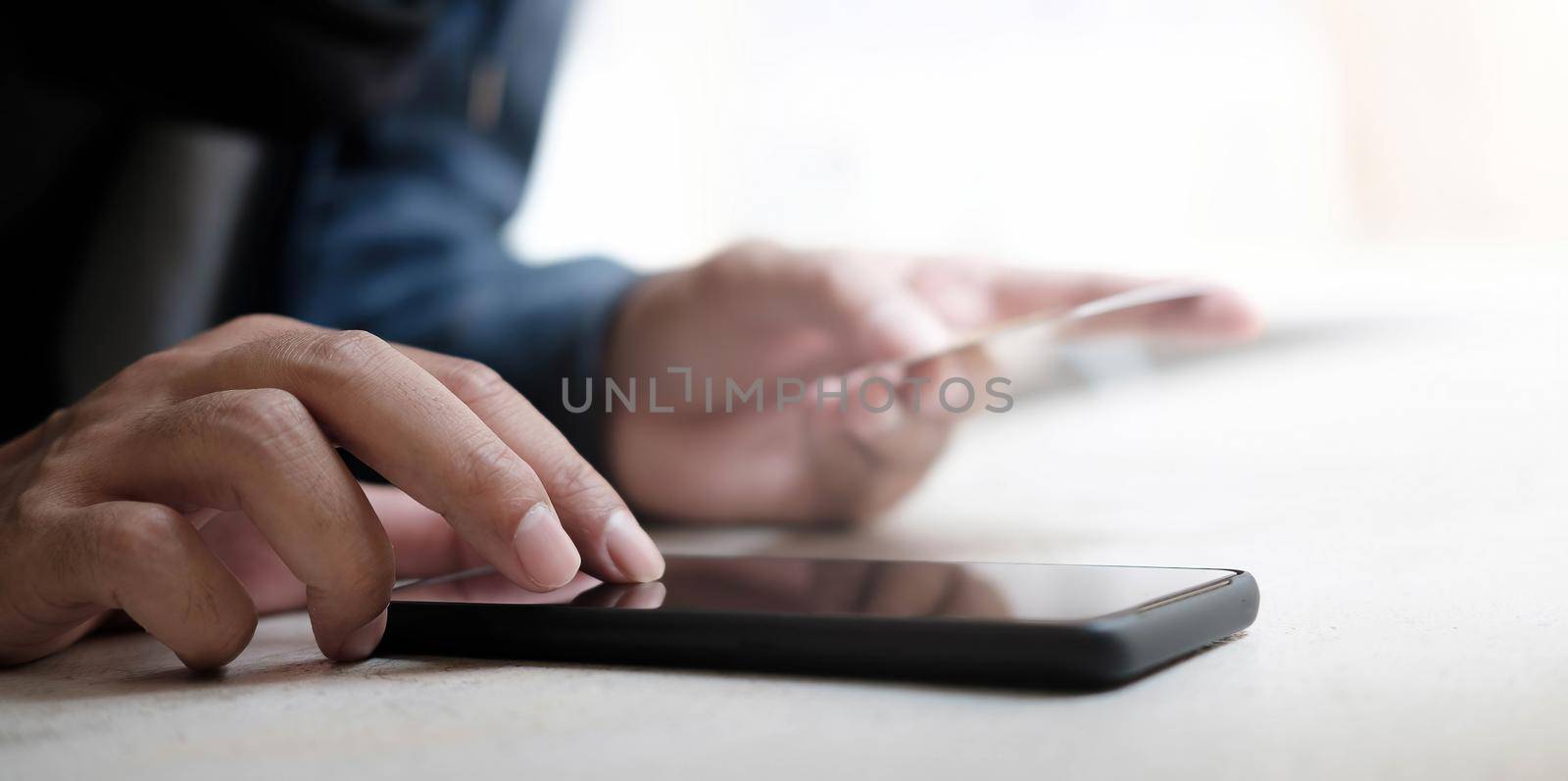 Online payment,Man's hands holding a credit card and using smart phone for online shopping by wichayada