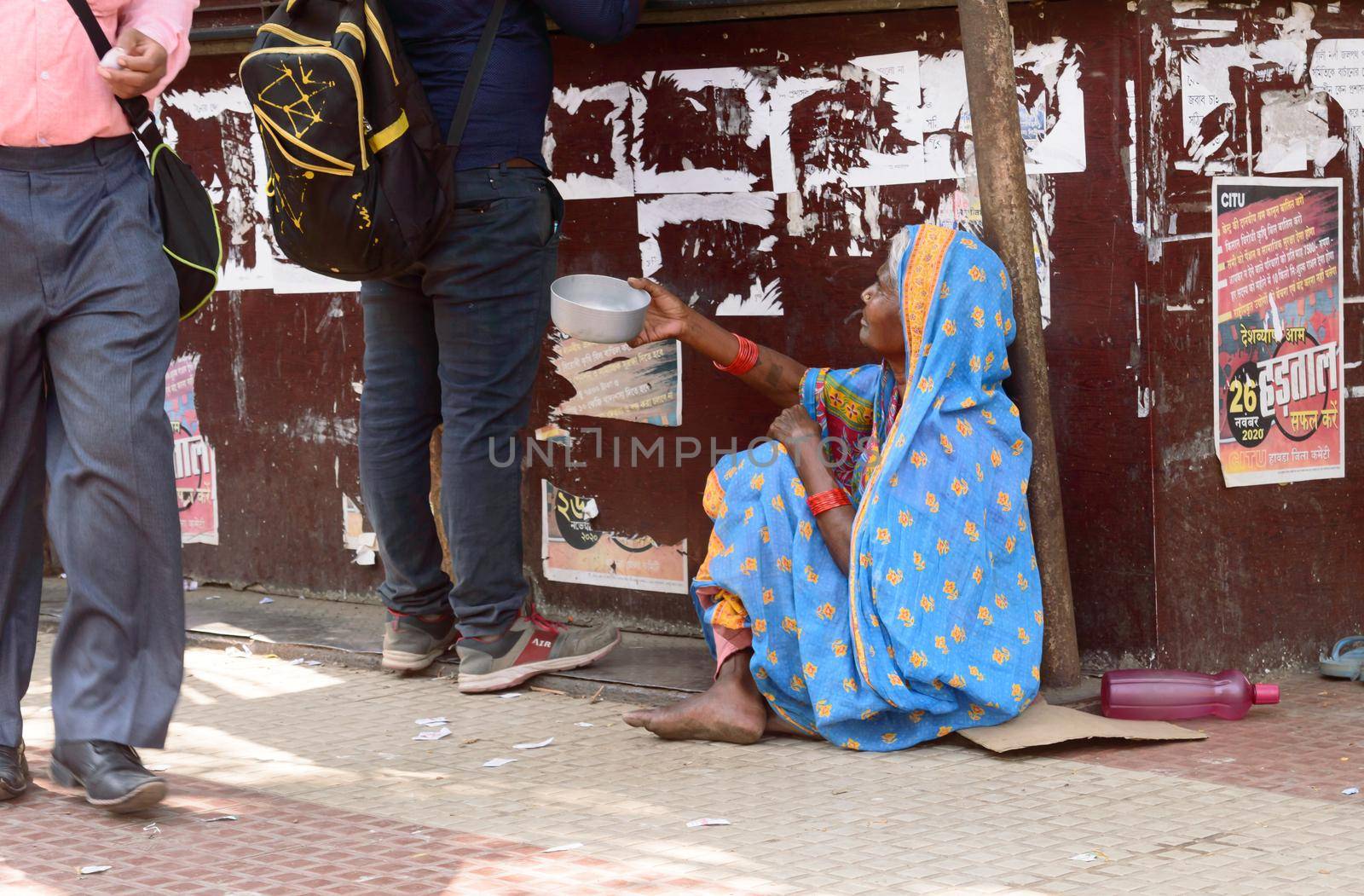 Old elderly Homeless woman begging in the city street corner of Kolkata, West Bengal, India South Asia Pacific March 15, 2021 by sudiptabhowmick