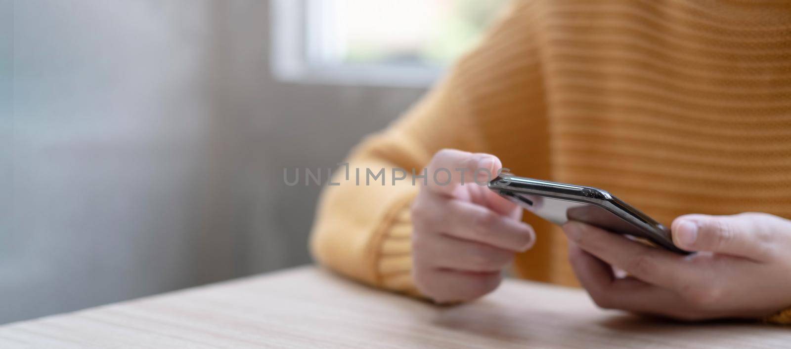 Online payment,woman's hands holding a credit card and using smart phone for online shopping.