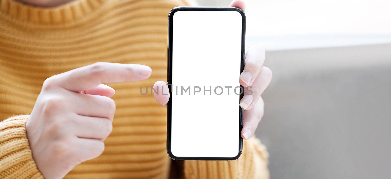 hand holding phone mobile and touching screen isolated on white background, mock-up smartphone matte black color by wichayada
