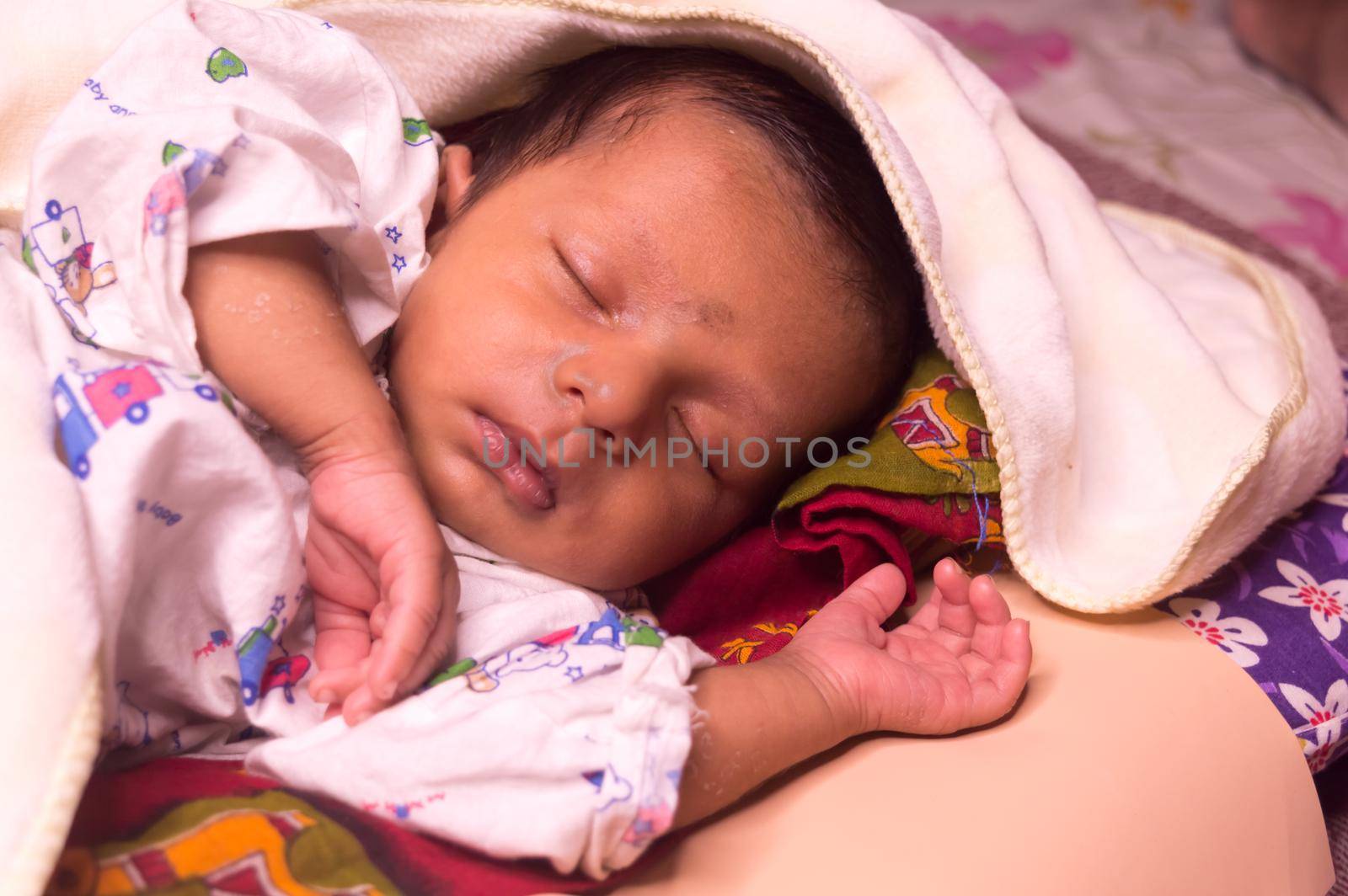 Close up face of cute sleeping newborn baby boy in drowsy eyes with sleepy mood. One month old Sweet infant toddler Closeup portrait. Indian ethnicity. Front view. Child care peace tranquil background