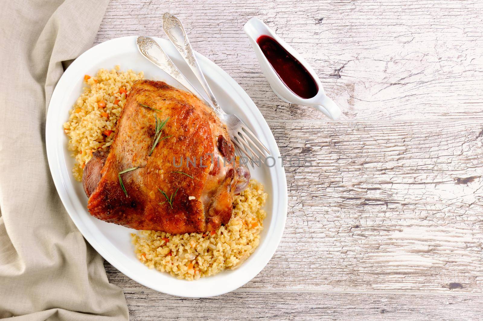 Baked turkey thigh with garnish bulgur and vegetables