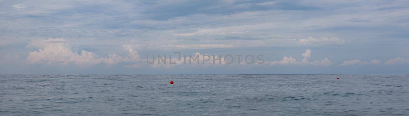 Morning seascape with clouds and buoys