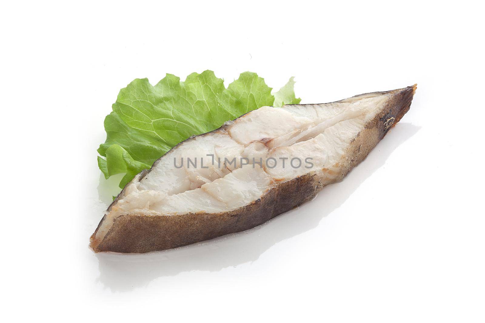Roasted halibut steak with fresh green lettuce