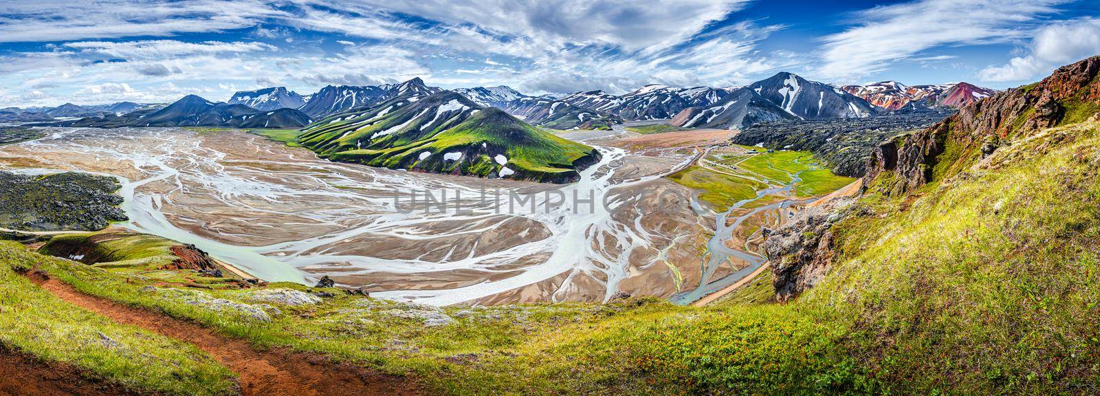 Panoramic landscape view of colorful rainbow volcanic Landmannalaugar mountains, volcanoes, lava fields, crater, water streams and floods at blue sky with clouds, Iceland, summer