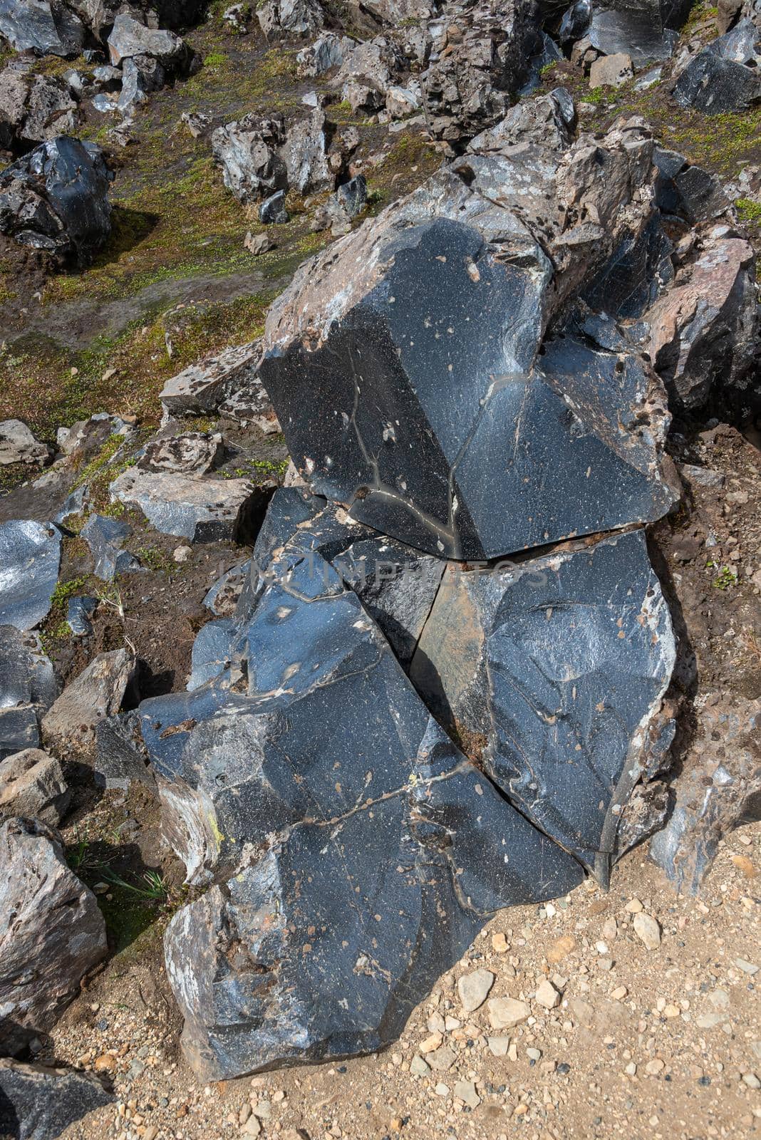 Volcanic glass rock known as obsidian found in lava fields formed by polymerized magma during volcanic eruption in rhyolitic silica, Iceland by neurobite
