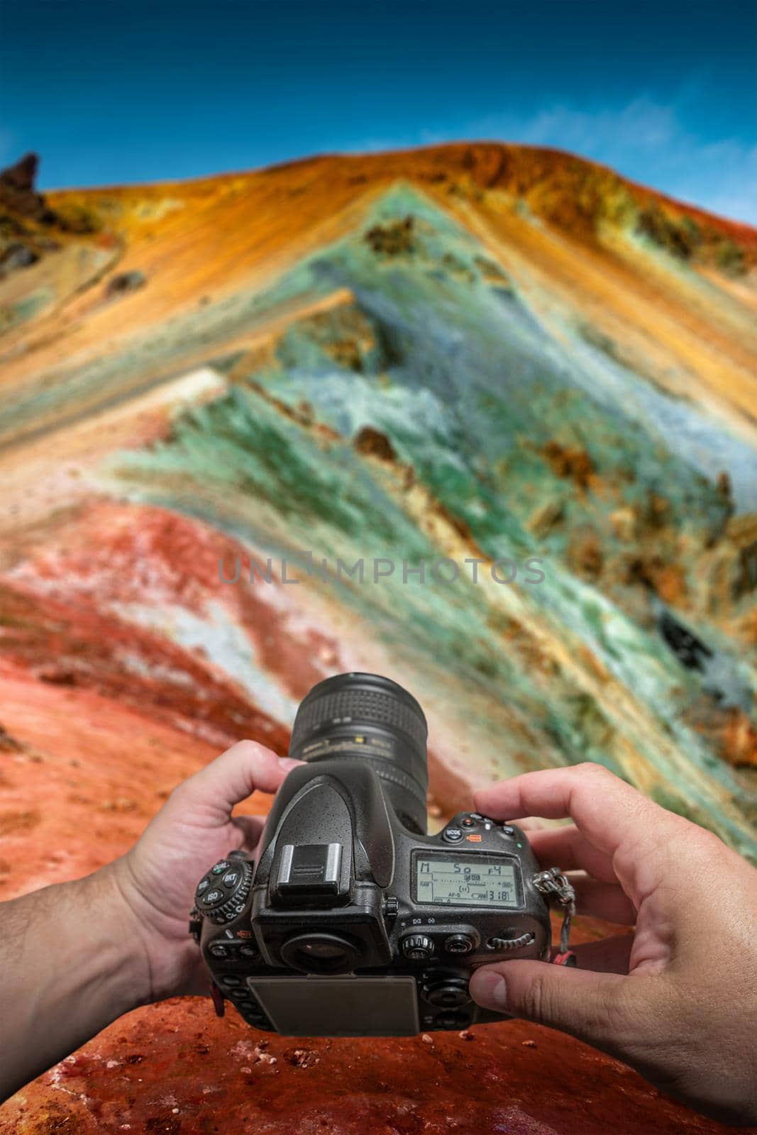 Making a photo with a camera of colorful Icelandic rainbow volcanic Landmannalaugar mountains, an iconic volcanic mount Brennisteinsalda in Iceland, summer