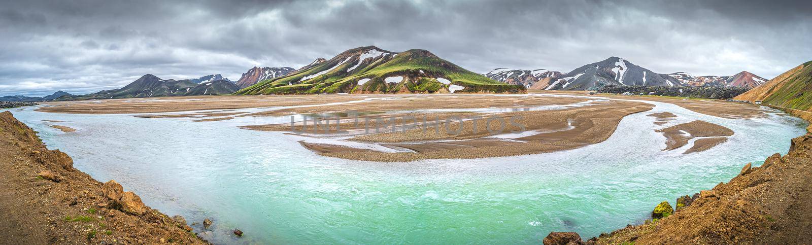 Panoramic view of colorful volcanic rainbow Landmannalaugar mountains, camping site and flooding with river in Iceland, summer