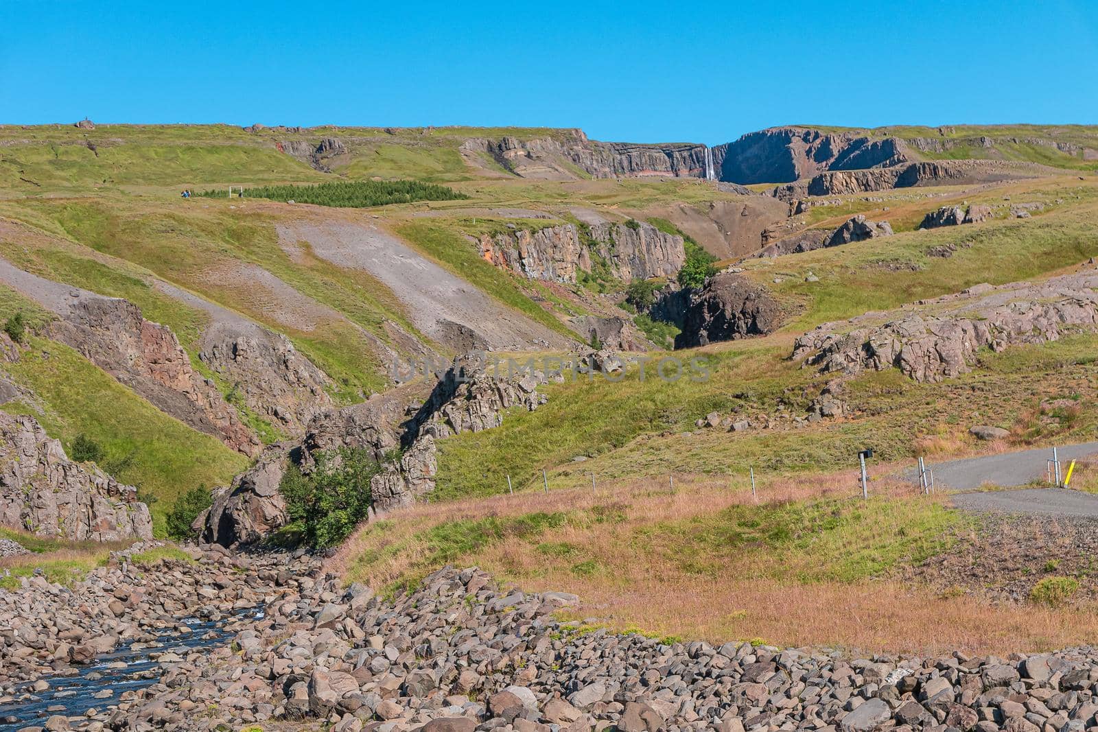 Valley in front of tallest Icelandic waterfall Hengifoss and hiking trail to it, Iceland, sunny day, blue sky