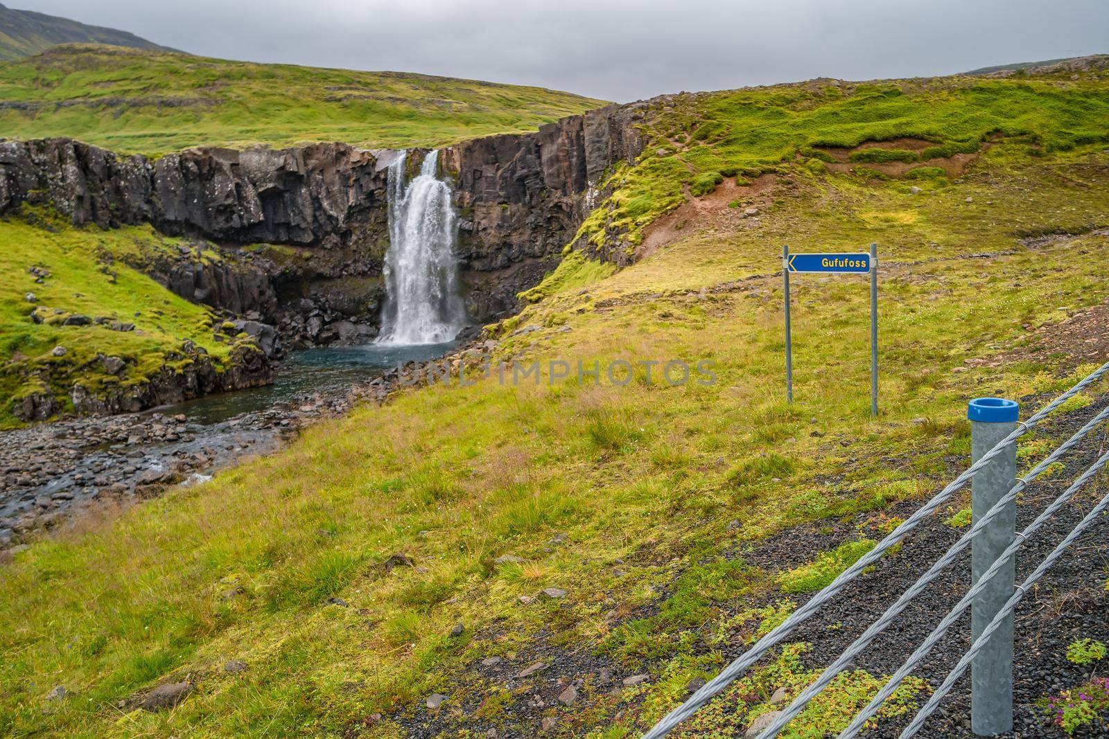 Lonely waterfall called Gufufoss near the road with a sign spelt its name at East Iceland