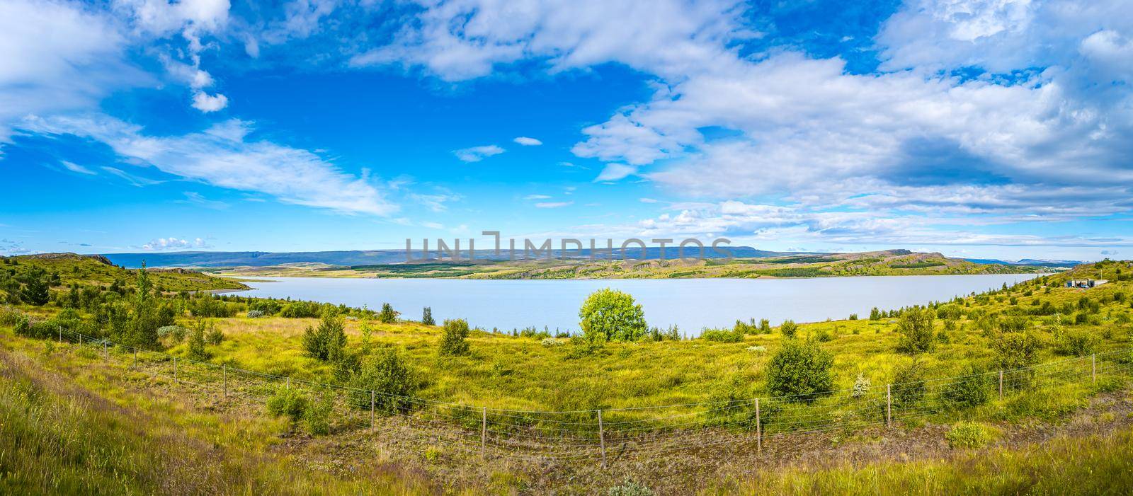 Panoramic view over huge Lagarfjot lake in Iceland at sunny day and blue sky, summer by neurobite
