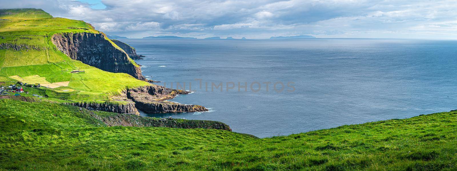 Panoramic view over mythical Faroe Island Mykines in the middle of Atlantic Ocean with a lot of puffins, parrot like seabirds
