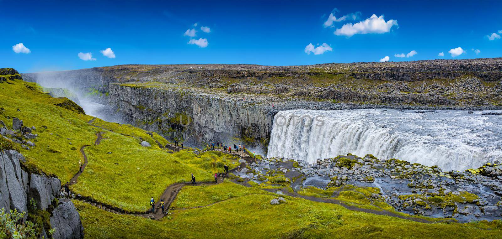Panoramic view over biggest and most powerful waterfall in Europe called Dettifoss in Iceland, near lake Myvatn, at blue sky